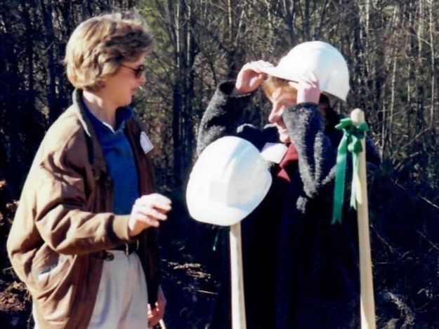 Mary Henderson talking with a person in a construction hat circa 1995